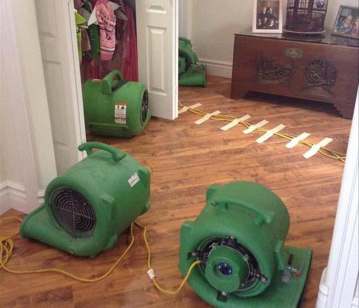 Drying process with 4 air movers at the entry of a residential property after water damage affected tile flooring and walls